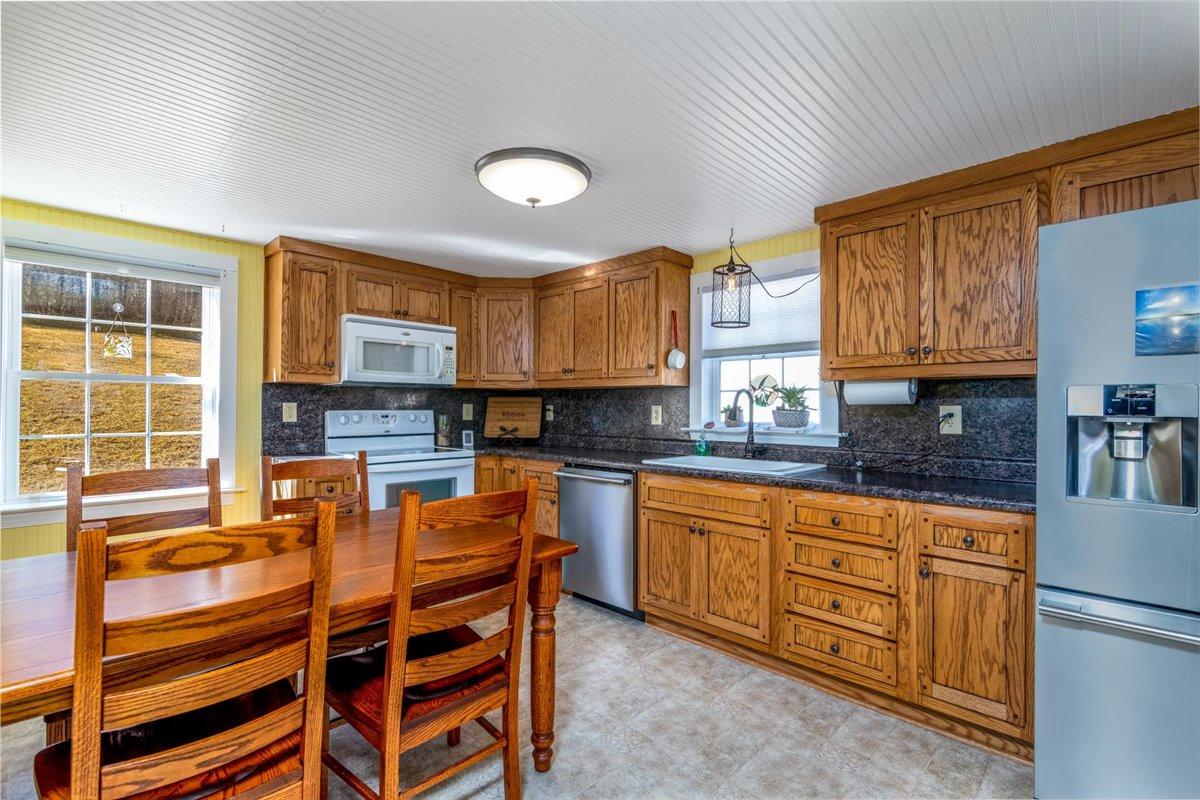 2717 Thompson Ridge Road Ferrum, VA 24088 - Photo 6 of 25 a kitchen with a refrigerator and a stove top oven
