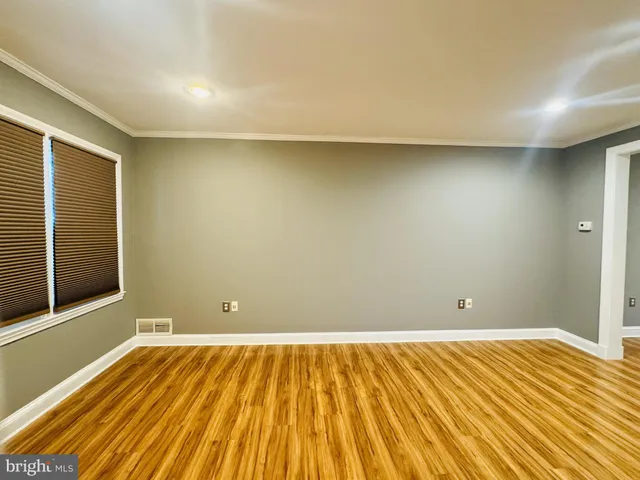 a view of a room with wooden floor and a wooden floor