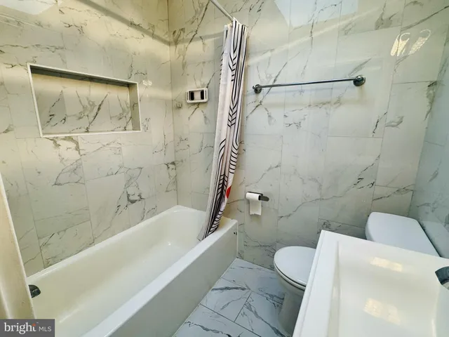 a bathroom with a toilet and a bathtub