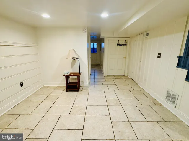a view of a livingroom with an empty space and a hallway