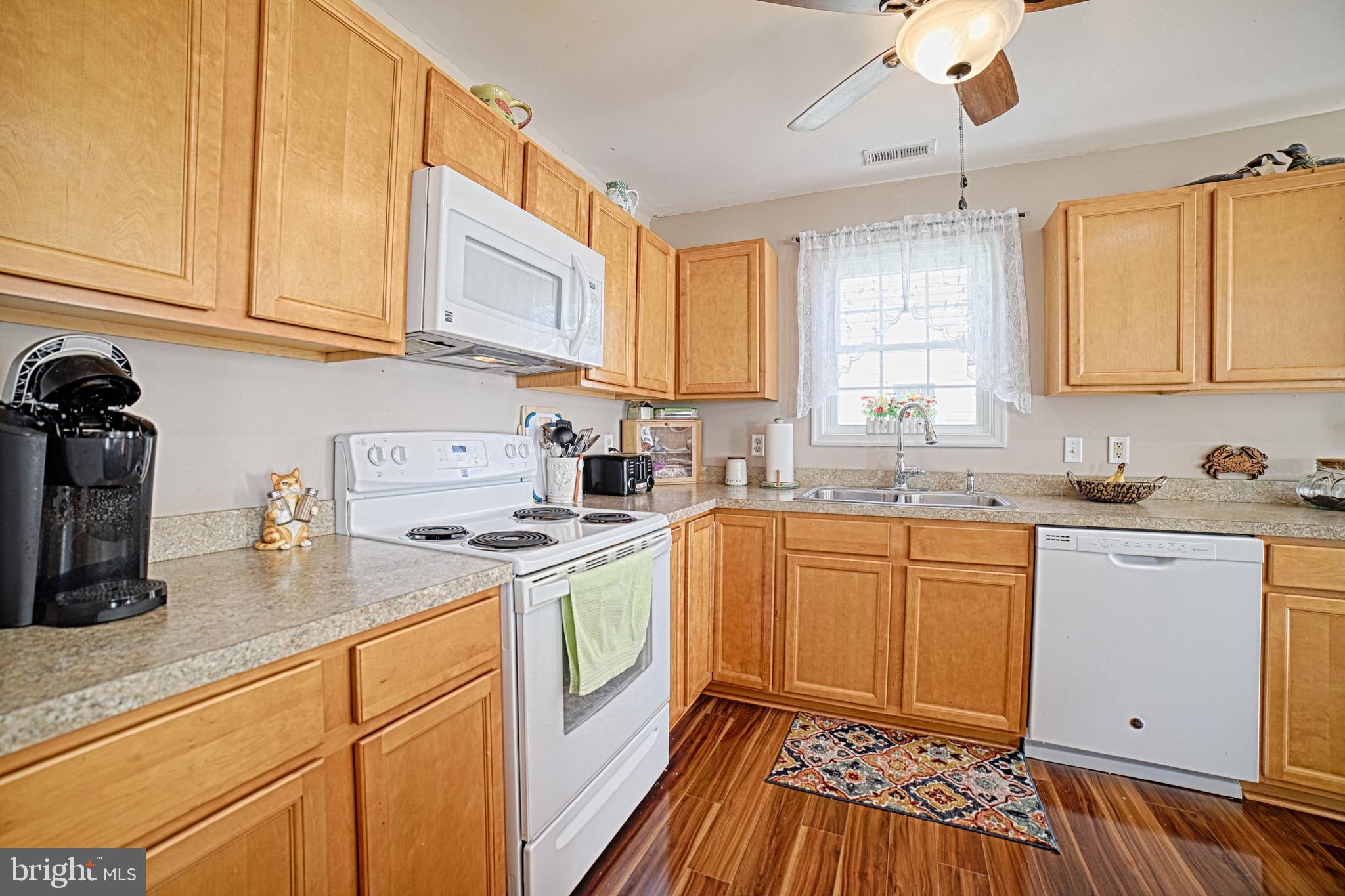 130 Walnut Street Ridgely, MD 21660 - Photo 11 of 27 a kitchen with granite countertop white cabinets and white appliances
