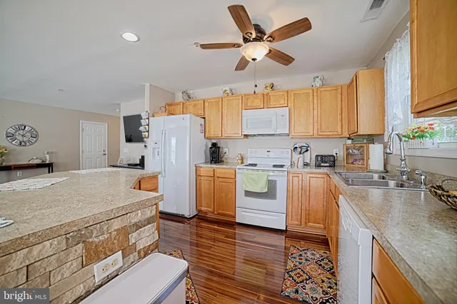 a kitchen with a stove a refrigerator and a sink