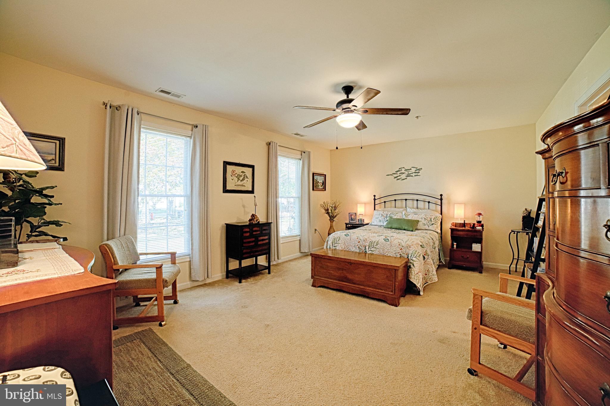 130 Walnut Street Ridgely, MD 21660 - Photo 13 of 27 a bedroom with a large bed a flat tv screen and a dresser