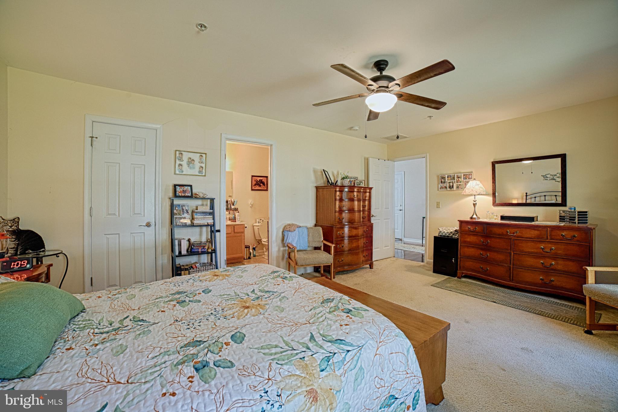 130 Walnut Street Ridgely, MD 21660 - Photo 14 of 27 a bedroom with a bed and a chandelier