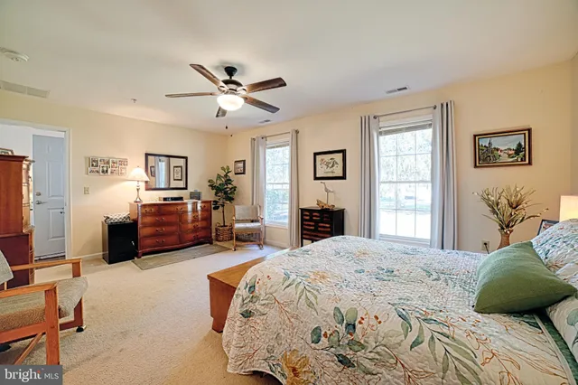 a bedroom with a bed dresser and window