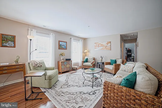 a living room with furniture a rug and a table