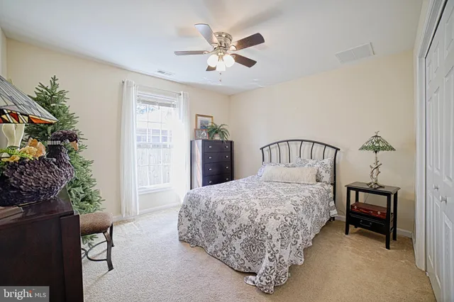 a bedroom with a bed dresser and a window