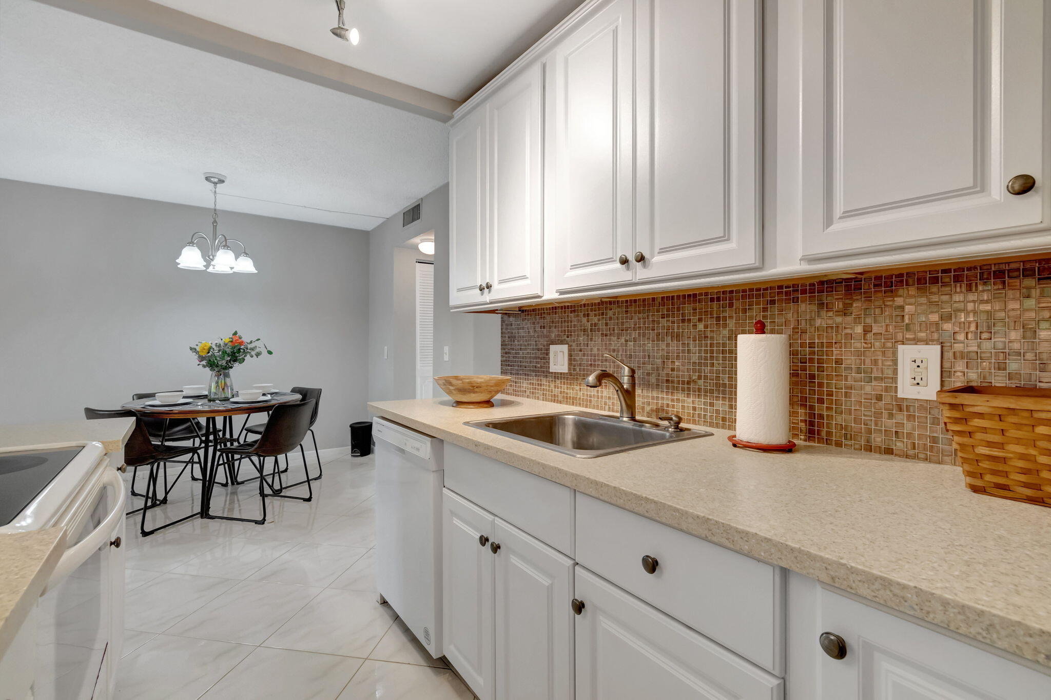3031 Cornwall East Boca Raton, FL 33434 - Photo 11 of 84 a kitchen with stainless steel appliances granite countertop a sink a stove and white cabinets