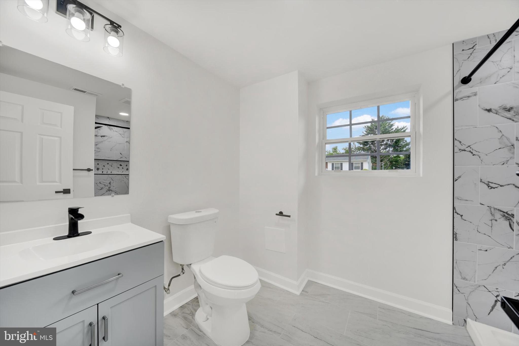 3808 Perryhurst Place Baltimore, MD 21236 - Photo 23 of 29 a bathroom with a sink a toilet and shower