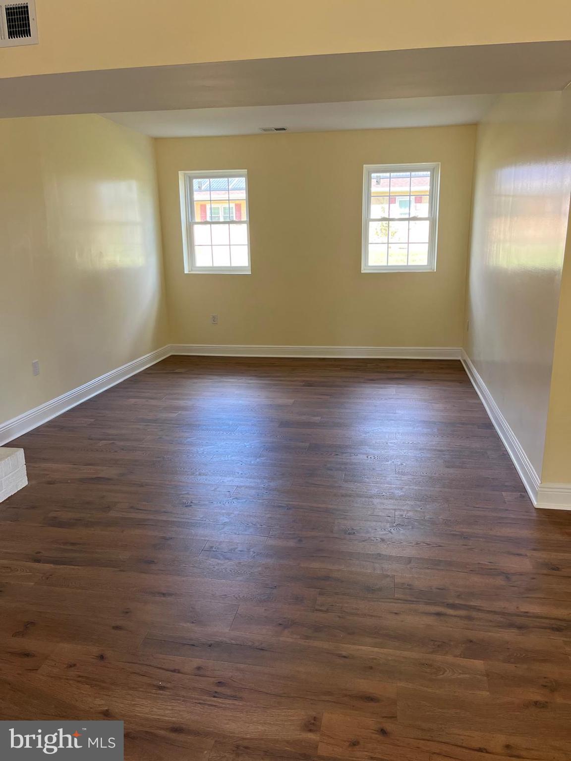 6706 Surratts Road Clinton, MD 20735 - Photo 12 of 24 an empty room with wooden floor and windows