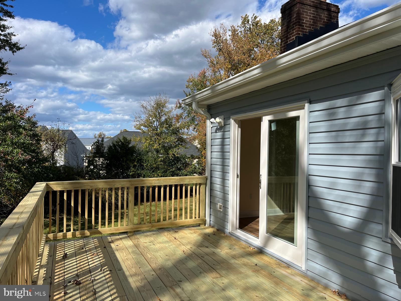 6706 Surratts Road Clinton, MD 20735 - Photo 18 of 24 a view of deck with wooden floor and fence and trees
