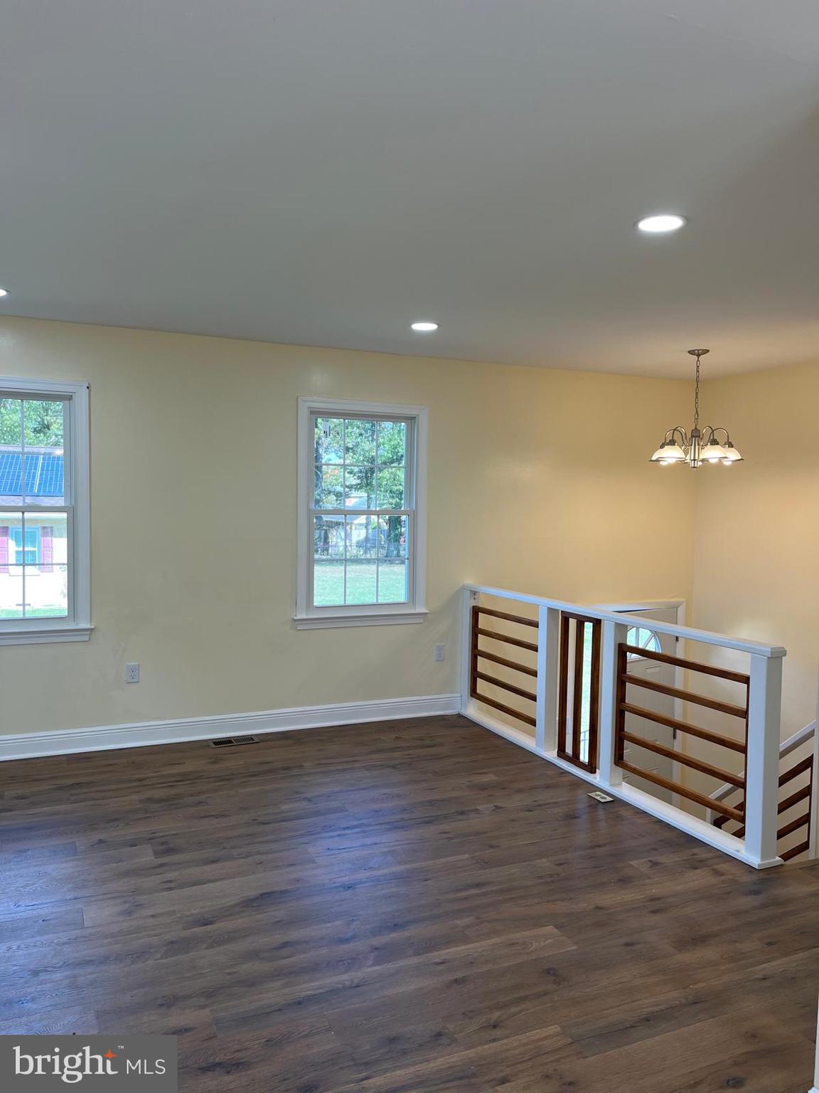 6706 Surratts Road Clinton, MD 20735 - Photo 2 of 24 a view of an empty room with a window and wooden floor