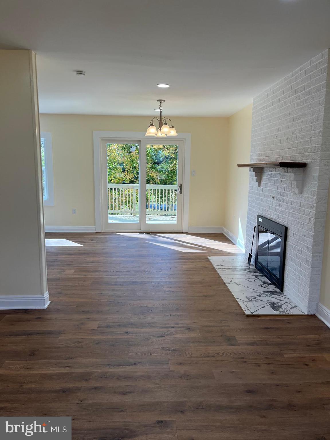 6706 Surratts Road Clinton, MD 20735 - Photo 6 of 24 a view of empty room with wooden floor and fan