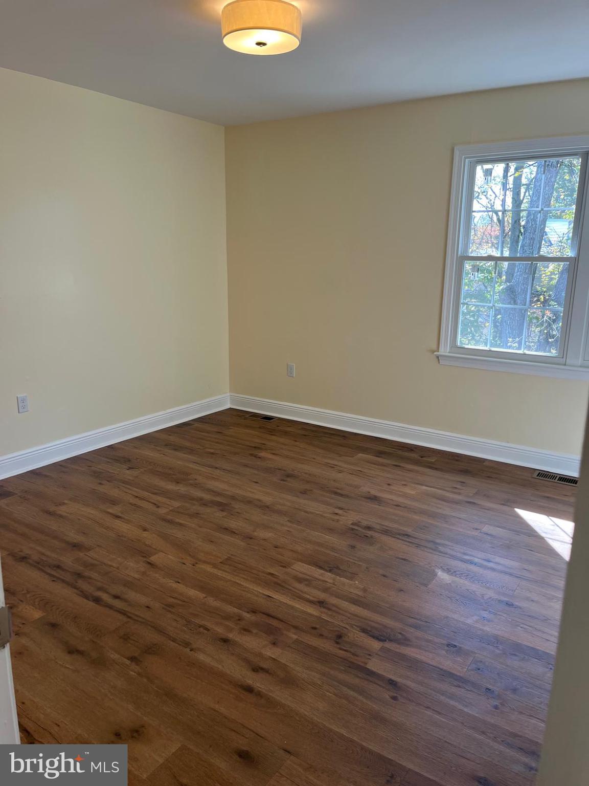 6706 Surratts Road Clinton, MD 20735 - Photo 8 of 24 an empty room with wooden floor and windows