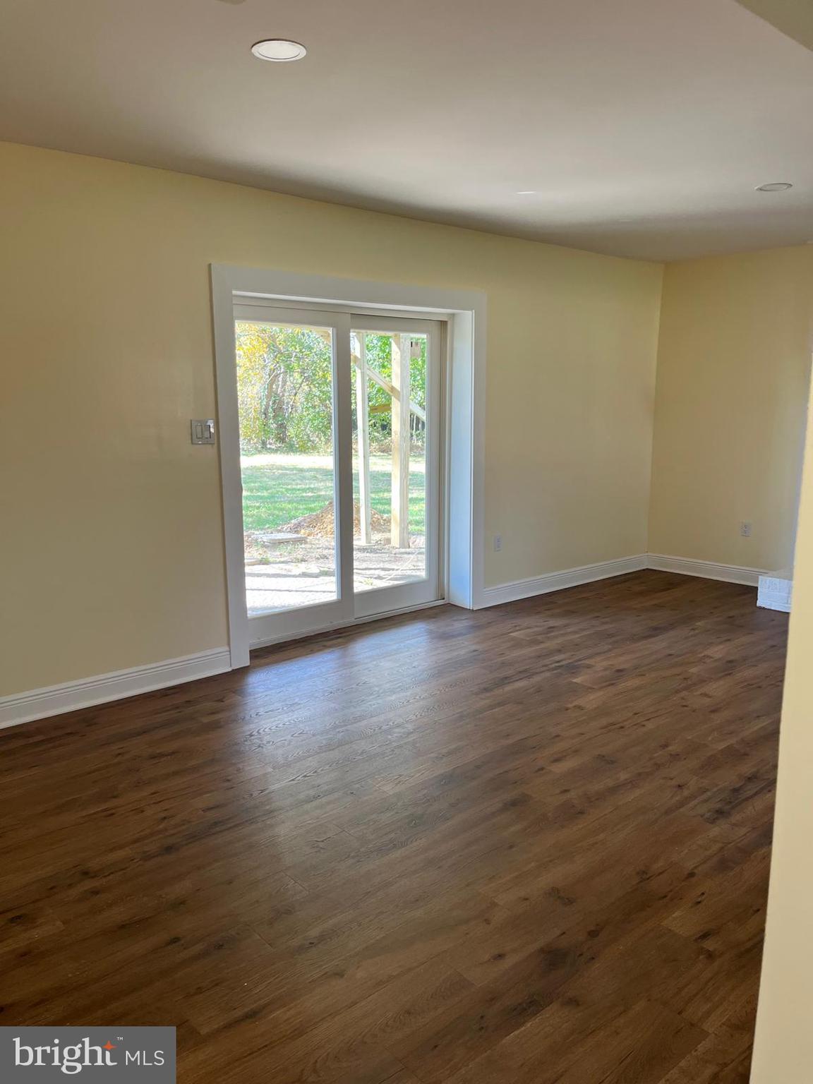 6706 Surratts Road Clinton, MD 20735 - Photo 10 of 24 an empty room with wooden floor and windows