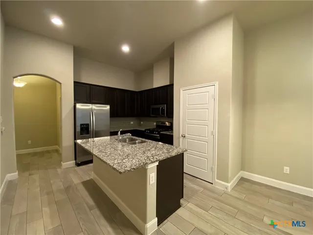 a kitchen that has a cabinets and a refrigerator