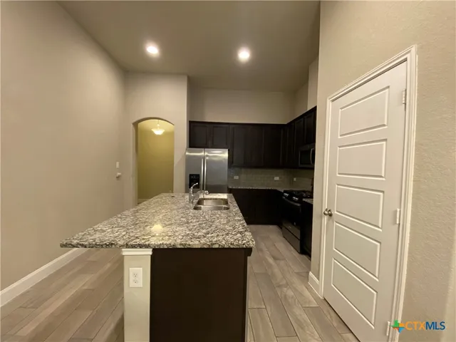 a kitchen with a sink and a refrigerator