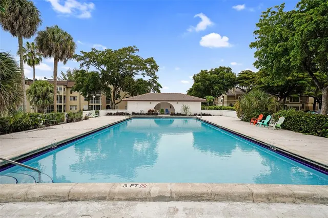 a view of a swimming pool with a yard