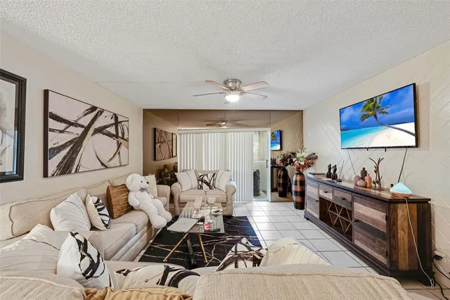 a living room with furniture a desk and chair with wooden floor