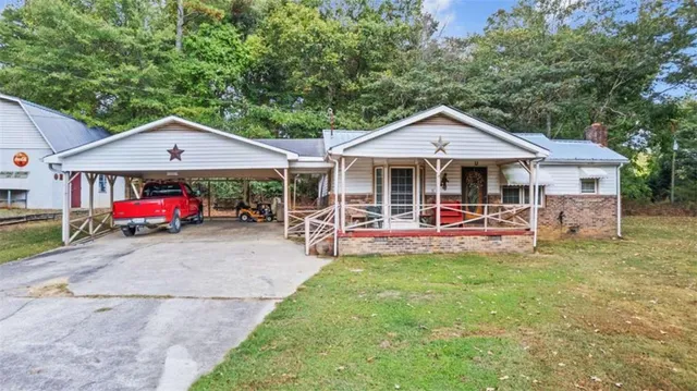 a view of a house with a yard and furniture