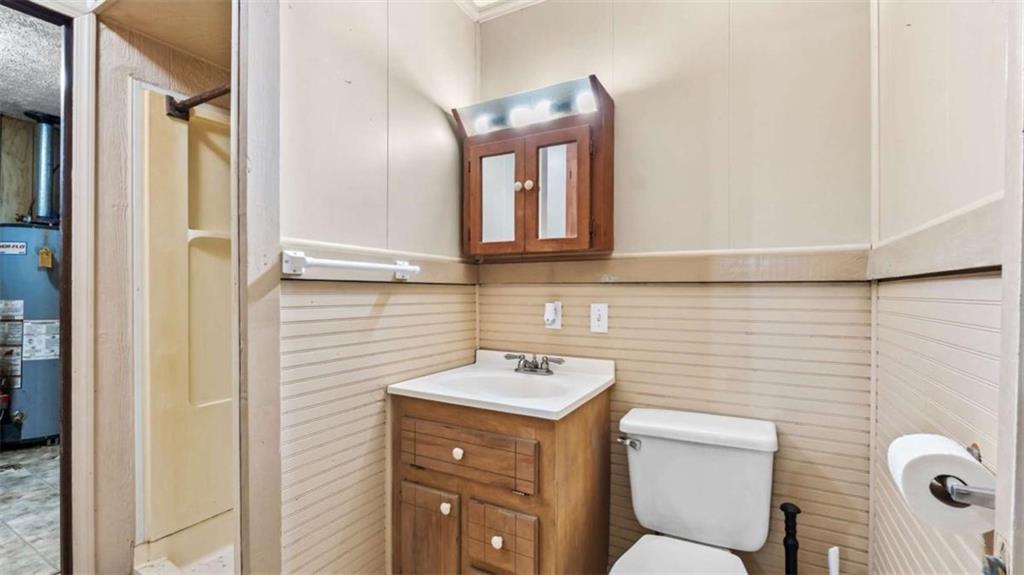 2557 Wax Road Southeast Aragon, GA 30104 - Photo 11 of 18 a bathroom with a toilet sink and mirror