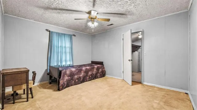 a bedroom with a bed and a ceiling fan