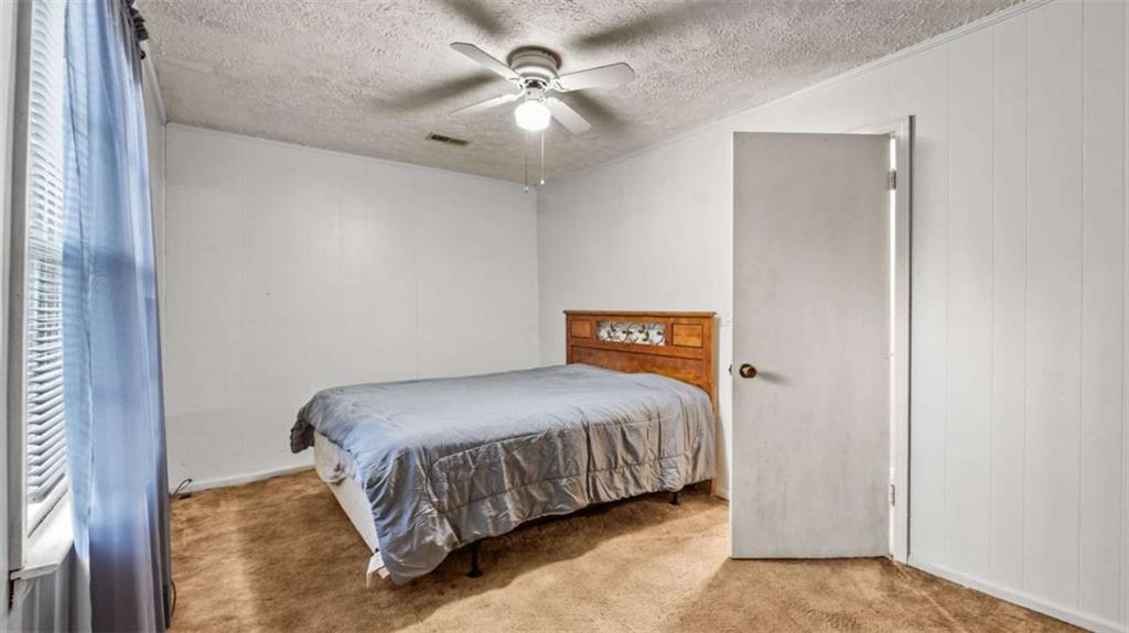 2557 Wax Road Southeast Aragon, GA 30104 - Photo 15 of 18 a bedroom with a bed and a ceiling fan