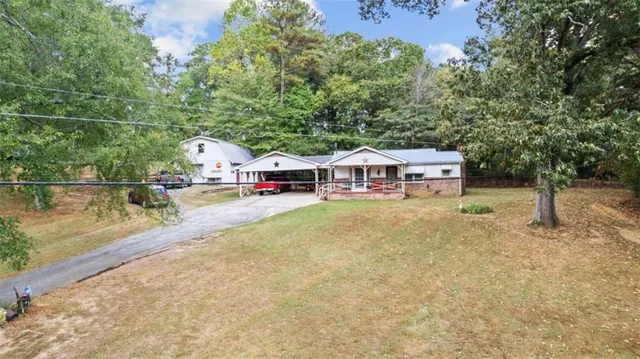 a view of house with outdoor space and swimming pool
