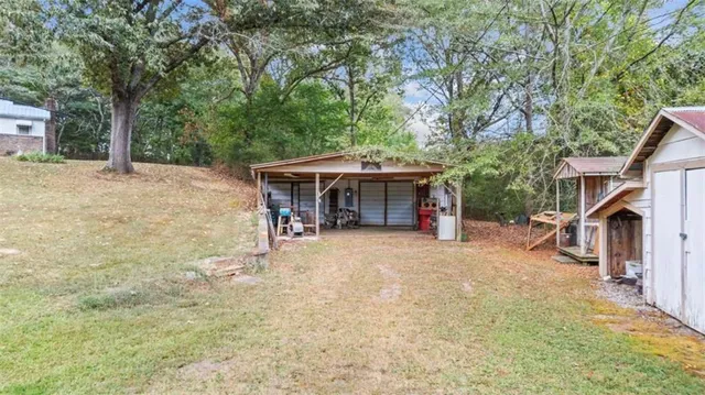 a view of a house with a backyard and a patio
