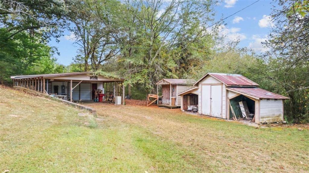 2557 Wax Road Southeast Aragon, GA 30104 - Photo 5 of 18 a front view of a house with a garden and trees