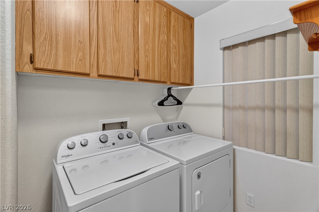 3376 Partridge Run Street Laughlin, NV 89029 - Photo 42 of 92 Functional laundry space featuring convenient overhead cabinetry and a hanging rod.