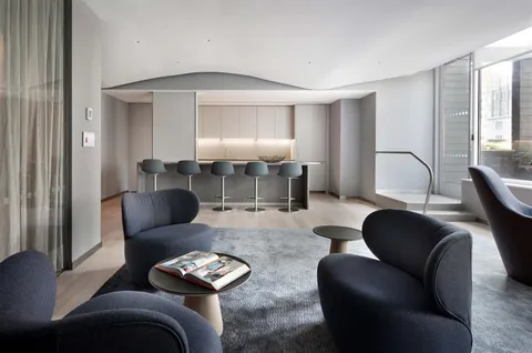 a living room with furniture and a lamp