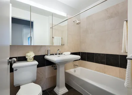 a bathroom with a sink a toilet and bathtub