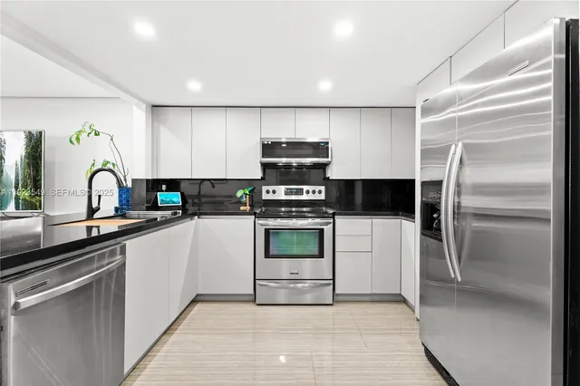 a kitchen with a refrigerator and a sink