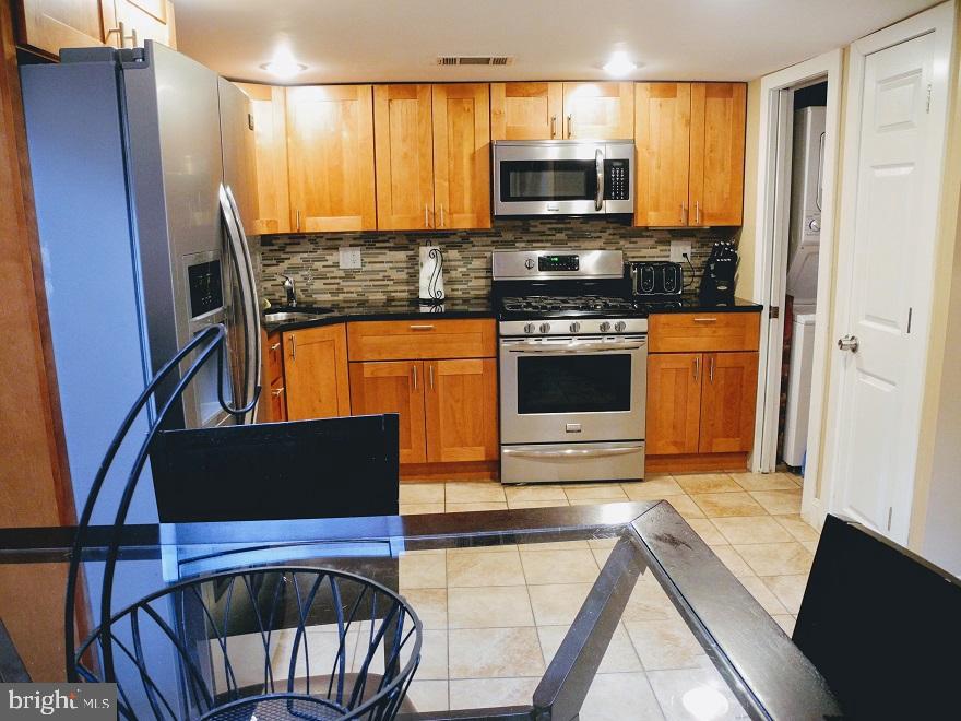 1933 Rodman Street Philadelphia, PA 19146 - Photo 2 of 21 a kitchen with stainless steel appliances a stove microwave and a refrigerator