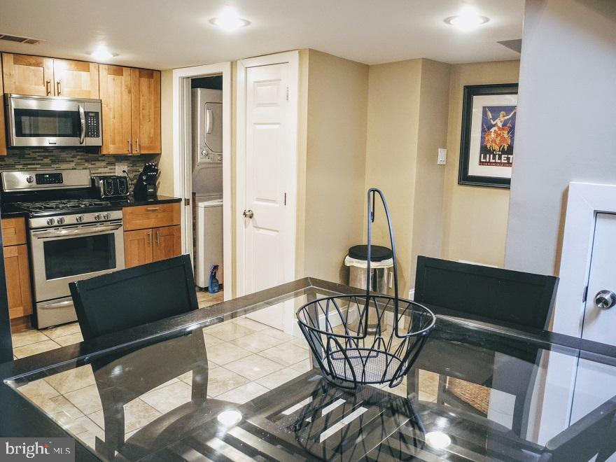 1933 Rodman Street Philadelphia, PA 19146 - Photo 3 of 21 a kitchen with stainless steel appliances kitchen island granite countertop a refrigerator and microwave
