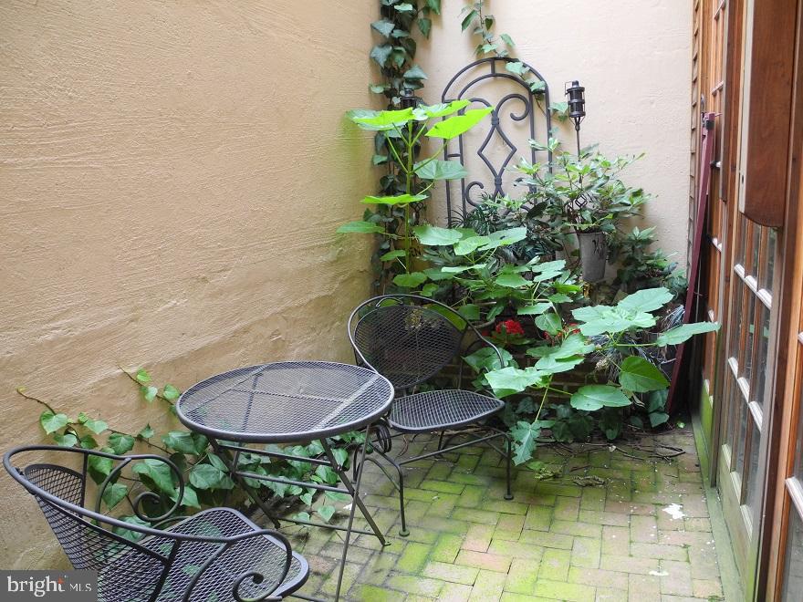 1933 Rodman Street Philadelphia, PA 19146 - Photo 10 of 21 a backyard with table and chairs with potted plants