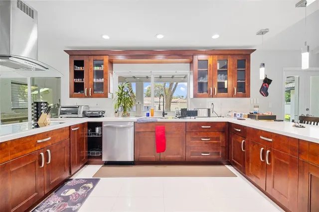 a large kitchen with stainless steel appliances granite countertop wooden cabinets a sink and dishwasher