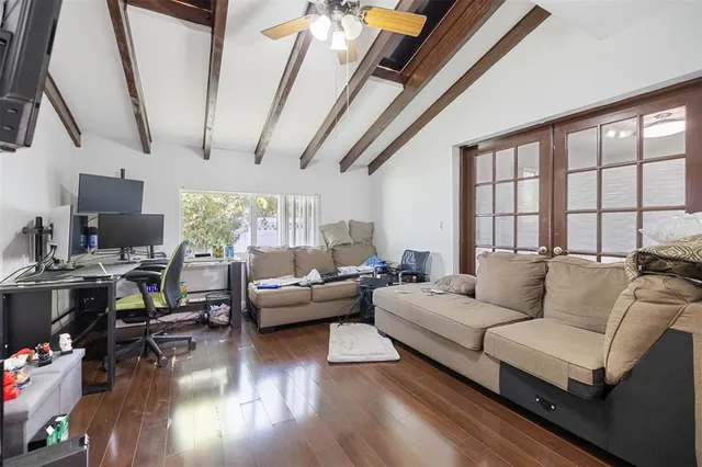 a living room with furniture and a wooden floor