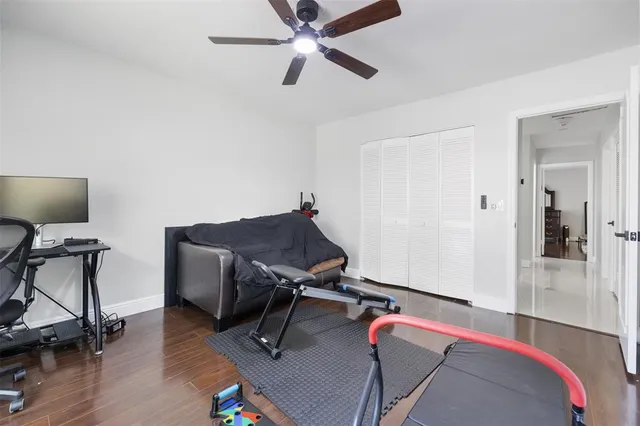 a view of a workspace with furniture and wooden floor