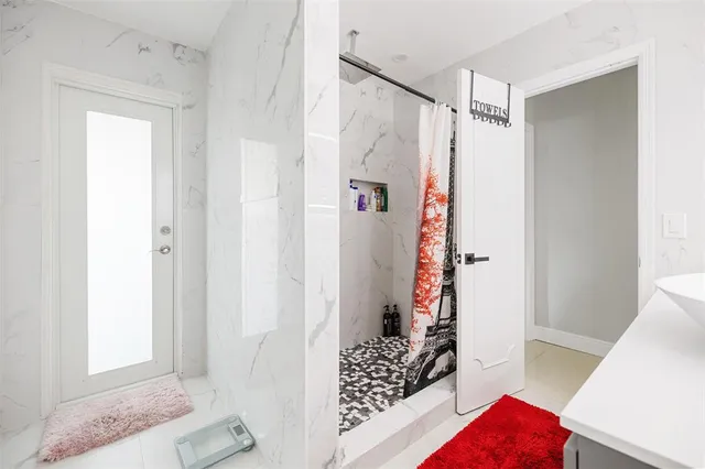 a bathroom with a bathtub and shower