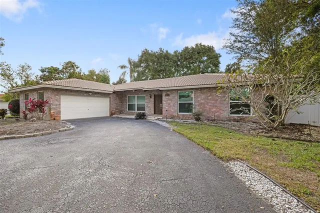 a view of a house with a yard and a garage