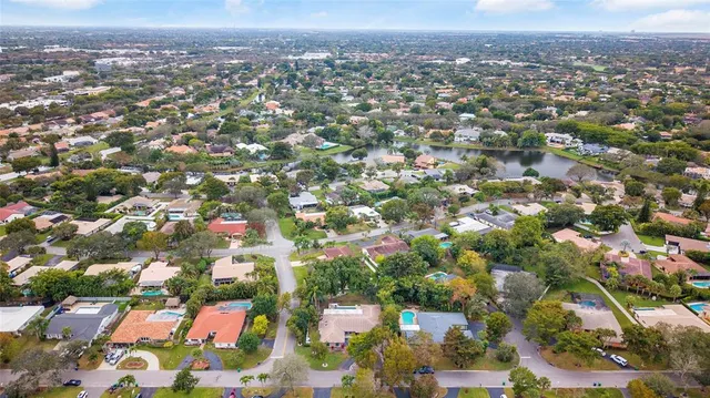 an aerial view of residential houses with city view