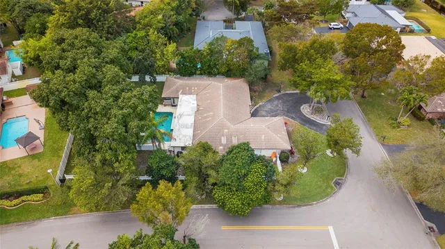 an aerial view of a house with a yard and garden