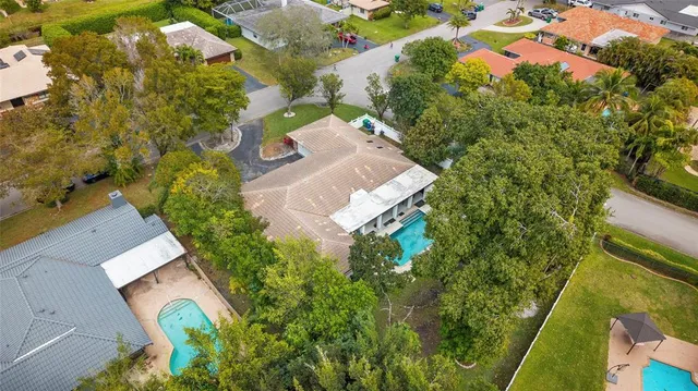an aerial view of a house with swimming pool and garden space