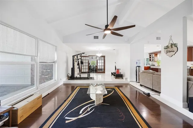 a room with wooden floor and white walls