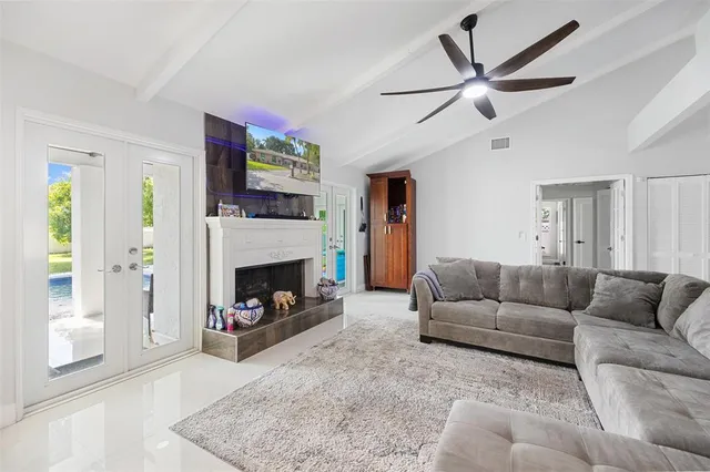 a living room with furniture a flat screen tv and a fireplace