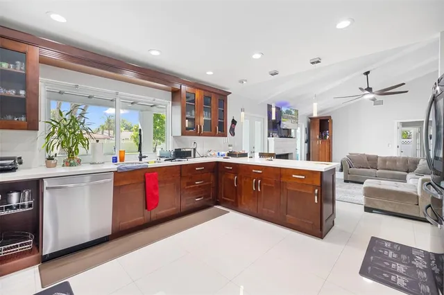 a kitchen with stainless steel appliances kitchen island granite countertop a sink and cabinets