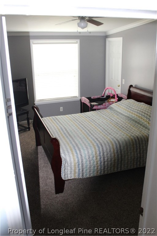 6520 Faircloth Bridge Road Stedman, NC 28391 - Photo 15 of 39 a bed sitting in a bedroom next to a window