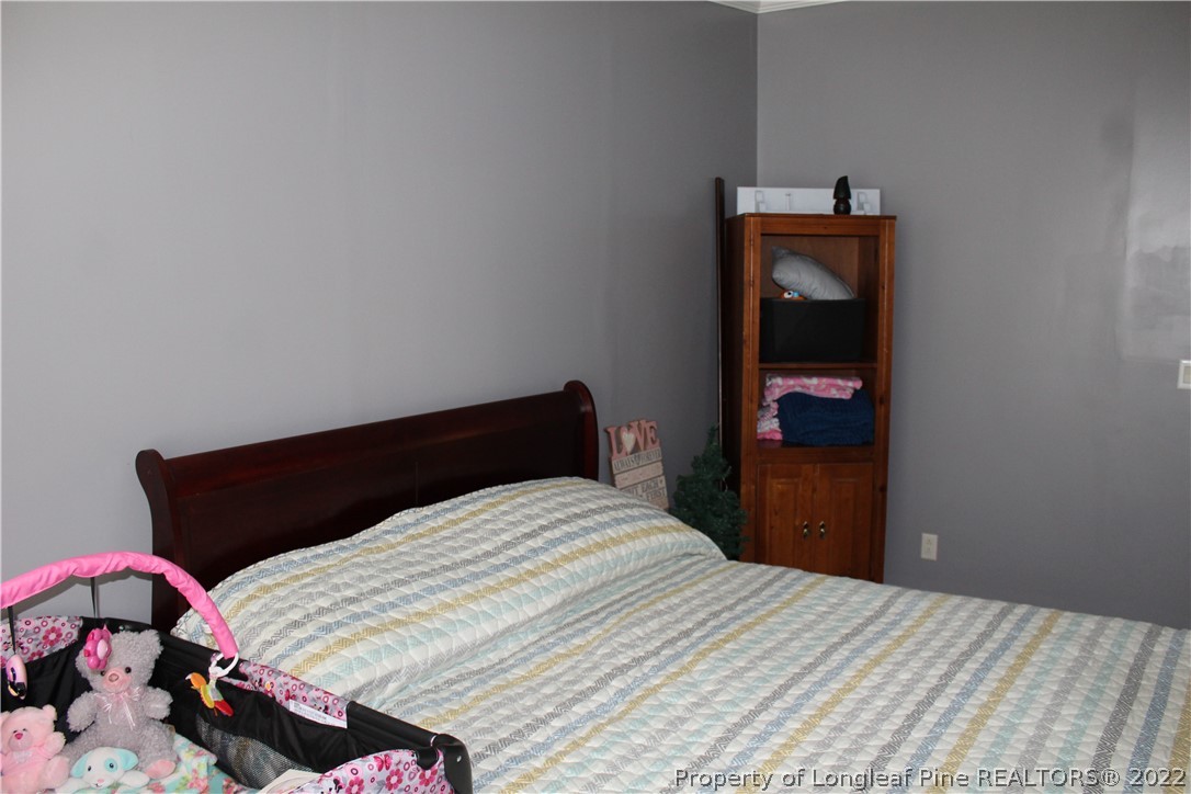 6520 Faircloth Bridge Road Stedman, NC 28391 - Photo 20 of 39 a bedroom with a bed and a window
